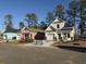 Exterior of colorful new construction homes with a well-manicured lawn, landscaping, and sidewalks at 3135 Tiger Tail Rd., Conway, SC 29526