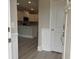Inviting foyer with wood-look floors, showcasing a modern kitchen with white cabinets and stainless steel appliances at 3135 Tiger Tail Rd., Conway, SC 29526