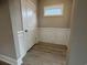 Bright foyer with wainscoting, light wood flooring, and a door leading to closet space at 3135 Tiger Tail Rd., Conway, SC 29526