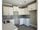 Modern kitchen featuring white cabinets, quartz countertops, and a stylish backsplash at 3135 Tiger Tail Rd., Conway, SC 29526