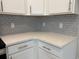Close up of white kitchen quartz countertops with gray subway tile backsplash and white cabinets at 3135 Tiger Tail Rd., Conway, SC 29526