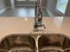 Close up of kitchen stainless steel sink with quartz countertops and modern chrome faucet at 3135 Tiger Tail Rd., Conway, SC 29526
