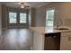 Open floor plan kitchen and living room with gray vinyl floors and stainless steel dishwasher at 3135 Tiger Tail Rd., Conway, SC 29526