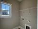 Functional laundry room with a window, shelving, and utility connections at 3135 Tiger Tail Rd., Conway, SC 29526