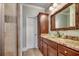 Bathroom vanity with granite countertop, bronze hardware, and a decorative mirror at 316 Shuffleboard Ct., Myrtle Beach, SC 29572