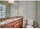 Bathroom featuring a granite countertop, vanity with storage, and modern fixtures at 316 Shuffleboard Ct., Myrtle Beach, SC 29572