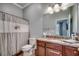 Bathroom with a shell themed shower curtain and vanity with a granite countertop at 316 Shuffleboard Ct., Myrtle Beach, SC 29572