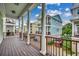 View from covered porch overlooking colorful two-story beach homes with a blue sky backdrop at 316 Shuffleboard Ct., Myrtle Beach, SC 29572