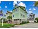 Multi-story home with a welcoming exterior, featuring green siding and well-manicured landscaping at 316 Shuffleboard Ct., Myrtle Beach, SC 29572