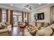 Comfortable living room featuring hardwood floors, a ceiling fan and an entertainment center at 316 Shuffleboard Ct., Myrtle Beach, SC 29572