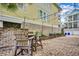 Brick patio area with wooden Adirondack chairs and cafe lights for outdoor enjoyment at 316 Shuffleboard Ct., Myrtle Beach, SC 29572