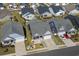 Aerial view of a neighborhood showcasing well-maintained homes, driveways, and landscaping at 3228 Goldenrain Ln., Little River, SC 29566