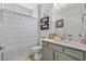 Bathroom featuring gray vanity, tub with shower, and modern fixtures at 3228 Goldenrain Ln., Little River, SC 29566