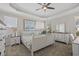 Bright main bedroom featuring tray ceiling, a ceiling fan, carpet and coastal decor at 3228 Goldenrain Ln., Little River, SC 29566