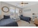 Bright guest bedroom with two twin beds, ceiling fan, and cozy decor at 3228 Goldenrain Ln., Little River, SC 29566