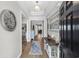 Bright foyer with wood floors, stylish decor, and a view into the open living spaces at 3228 Goldenrain Ln., Little River, SC 29566