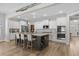 Bright kitchen with a large central island including seating and wine rack, and featuring white cabinets at 3228 Goldenrain Ln., Little River, SC 29566