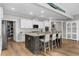 Spacious kitchen featuring an island with barstool seating, white cabinetry, and stainless steel appliances at 3228 Goldenrain Ln., Little River, SC 29566