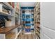 Walk-in pantry with custom shelving, providing ample storage space for food and kitchen essentials at 3228 Goldenrain Ln., Little River, SC 29566