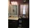 Bathroom with a large mirror, vanity with black cabinets, and a window with curtains at 330 Fairwood Terrace, Myrtle Beach, SC 29588