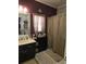 Bathroom with a large mirror, vanity with black cabinets, shower with curtain and towels at 330 Fairwood Terrace, Myrtle Beach, SC 29588