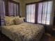 The bedroom has a decorative floral bedspread, two windows, and a view of the outside at 330 Fairwood Terrace, Myrtle Beach, SC 29588