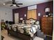 This main bedroom features a decorative bed frame, a ceiling fan, and a step to the bed at 330 Fairwood Terrace, Myrtle Beach, SC 29588