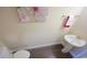 Cozy powder room featuring pedestal sink and wood flooring at 354 Glacier Way, Conway, SC 29526