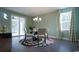 Bright dining room features modern chandelier, elegant round table, and sliding glass doors leading to outdoor space at 354 Glacier Way, Conway, SC 29526