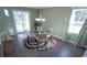 Bright dining area featuring modern chandelier, round glass table, and sliding glass doors to the backyard at 354 Glacier Way, Conway, SC 29526