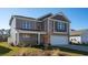 Charming two-story home featuring stone accents, a two-car garage, and neutral-colored siding at 354 Glacier Way, Conway, SC 29526