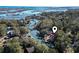 Breathtaking aerial view of a home nestled within a beautiful waterway and lush tree coverage at 3615 Sunfish St., Murrells Inlet, SC 29576