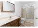 Well-lit bathroom with tile floors, a wood vanity, and a shower with sliding doors at 3615 Sunfish St., Murrells Inlet, SC 29576