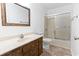 Bathroom features a wooden vanity with a mirror and a shower with sliding doors at 3615 Sunfish St., Murrells Inlet, SC 29576