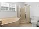 Bathroom features a corner soaking tub, glass enclosed shower, and tiled floors at 3615 Sunfish St., Murrells Inlet, SC 29576