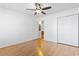 Bright bedroom with neutral walls, wood floors, a ceiling fan, and large closet space at 3615 Sunfish St., Murrells Inlet, SC 29576