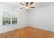 Cozy bedroom with laminate flooring, large window, and a modern ceiling fan at 3615 Sunfish St., Murrells Inlet, SC 29576