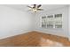 Bright bedroom featuring hardwood floors, a ceiling fan, and a large window at 3615 Sunfish St., Murrells Inlet, SC 29576