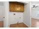 Functional laundry area with overhead cabinets and hardwood floors at 3615 Sunfish St., Murrells Inlet, SC 29576