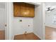 Small laundry room with wood cabinets, wood floors, and a view into a bedroom at 3615 Sunfish St., Murrells Inlet, SC 29576