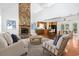 Bright, open living space featuring a stone fireplace and modern kitchen, ideal for Gathering gatherings and entertaining at 3615 Sunfish St., Murrells Inlet, SC 29576