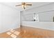 Bright living room features wood floors, a ceiling fan, and a charming view to the lower level at 3615 Sunfish St., Murrells Inlet, SC 29576