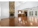 Spacious living area showcasing hardwood floors and an inviting fireplace, flowing into the adjacent kitchen at 3615 Sunfish St., Murrells Inlet, SC 29576