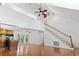 Bright living room with wood floors, stairs, skylight, doors to a porch, and an open floor plan at 3615 Sunfish St., Murrells Inlet, SC 29576