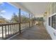 Spacious porch with a wooden railing, offering stunning waterfront views and outdoor living space at 3615 Sunfish St., Murrells Inlet, SC 29576