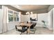 Bright dining area with modern chandelier, large windows, and an elegant wooden table at 362 Glacier Way, Conway, SC 29526