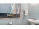 Stylish powder room featuring a pedestal sink, sailboat art, and a soft, neutral color palette at 362 Glacier Way, Conway, SC 29526