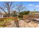 Inviting wood deck and steps lead to a backyard with a privacy fence and shade trees at 3816 James Pl., Little River, SC 29566