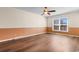 Bright bedroom with hardwood floors, a ceiling fan, and a large window offering great natural light at 3816 James Pl., Little River, SC 29566