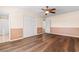 Spacious bedroom featuring hardwood floors, a ceiling fan, and a double door closet for ample storage at 3816 James Pl., Little River, SC 29566